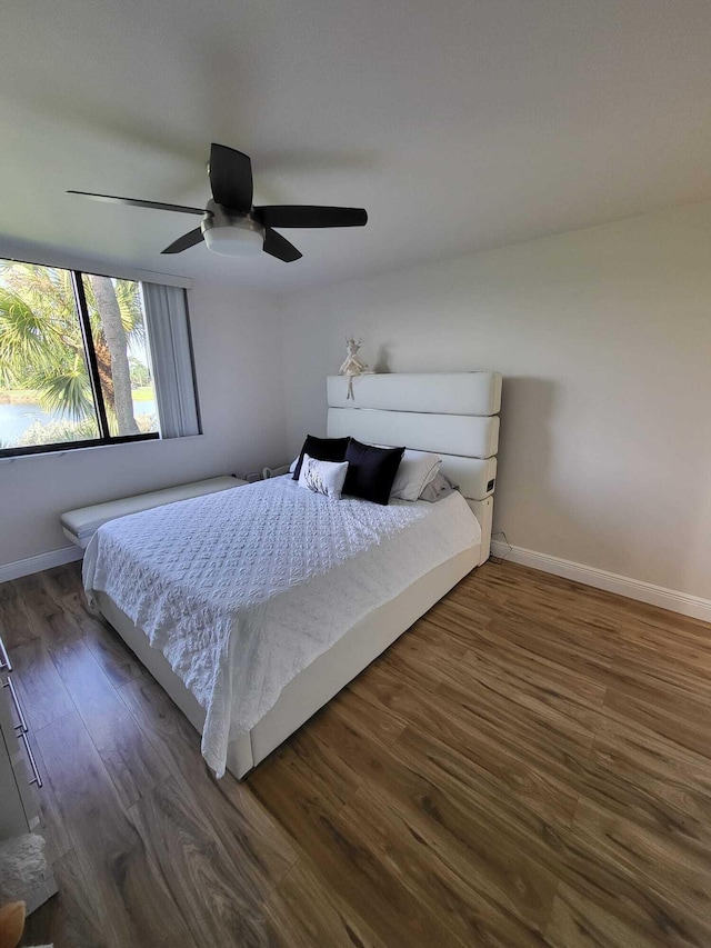 bedroom with dark wood-type flooring and ceiling fan