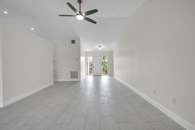 unfurnished living room featuring ceiling fan, a textured ceiling, and lofted ceiling