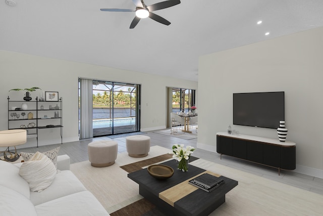 living area featuring baseboards, a ceiling fan, vaulted ceiling, and recessed lighting