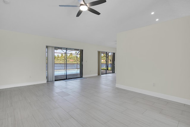 5625 Aspen Ridge Cir, Delray Beach, FL 33484 - unfurnished room with ceiling fan, baseboards, lofted ceiling, and recessed lighting