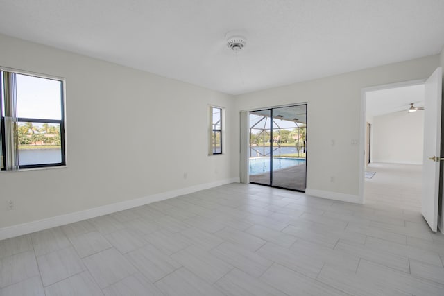 5625 Aspen Ridge Cir, Delray Beach, FL 33484 - spare room featuring baseboards and ceiling fan