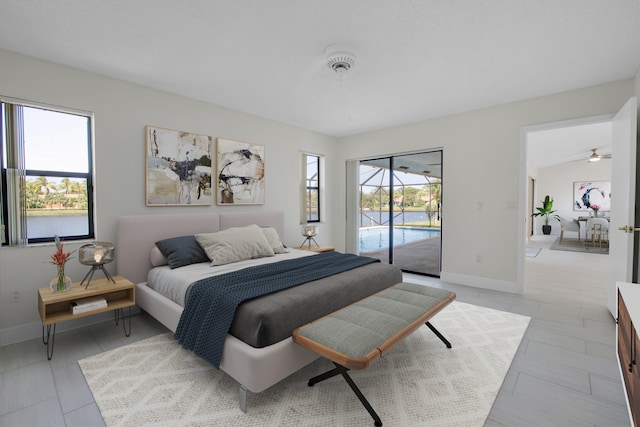 bedroom featuring lofted ceiling and access to exterior