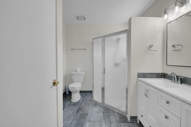 bathroom with a shower stall, vaulted ceiling, vanity, baseboards, and toilet