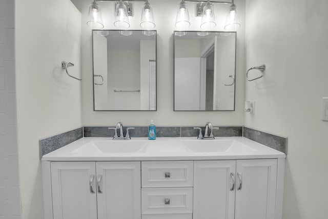 bathroom with a sink and double vanity