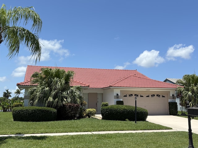5625 Aspen Ridge Cir, Delray Beach, FL 33484 - mediterranean / spanish-style home featuring a garage, a tiled roof, stucco siding, and concrete driveway