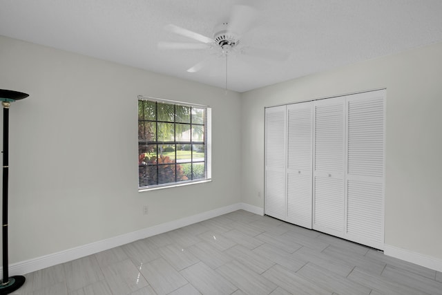 unfurnished bedroom with a closet, baseboards, and ceiling fan