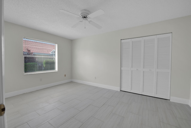 unfurnished bedroom featuring a textured ceiling, a closet, and ceiling fan