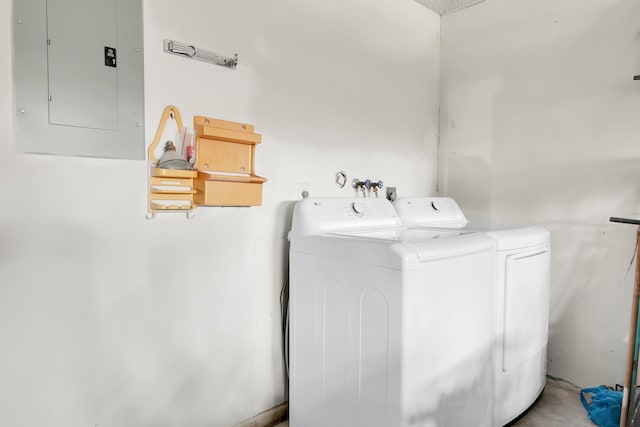 laundry area with electric panel, washing machine and clothes dryer, and laundry area