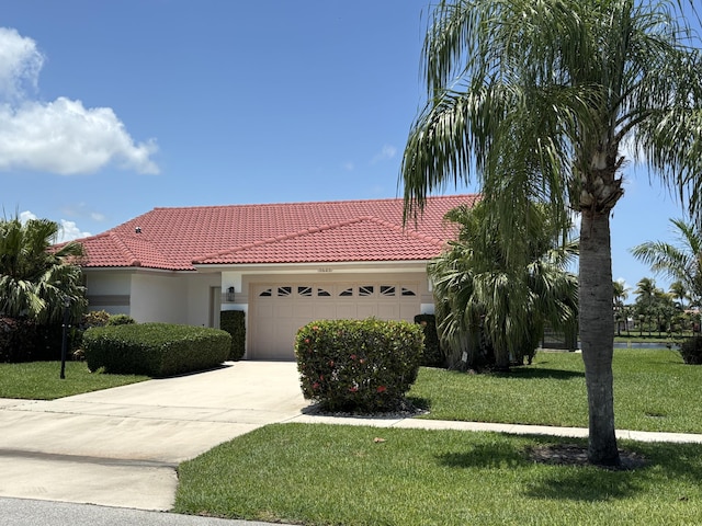 5625 Aspen Ridge Cir, Delray Beach, FL 33484 - view of front facade with a garage, a tiled roof, stucco siding, and a front yard