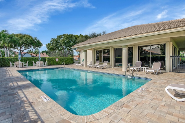 pool featuring a patio and fence