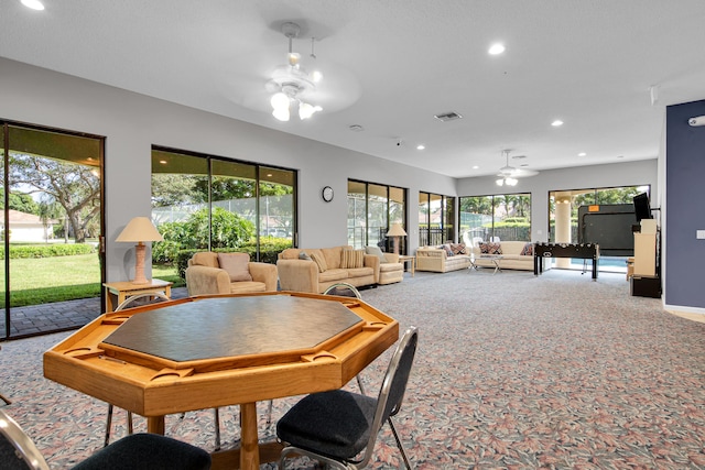 carpeted living area featuring ceiling fan, visible vents, and recessed lighting