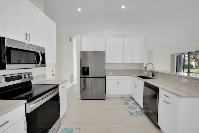 kitchen featuring sink, white cabinetry, stainless steel appliances, lofted ceiling, and light stone counters