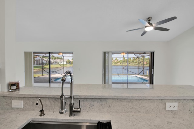 5625 Aspen Ridge Cir, Delray Beach, FL 33484 - kitchen view of a sink, a ceiling fan, and a large body of water