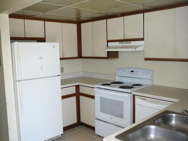 kitchen featuring white cabinets, sink, light tile patterned floors, and white appliances