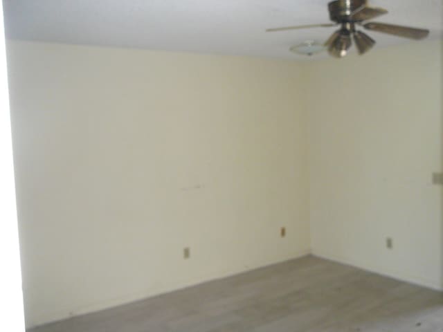 unfurnished room featuring ceiling fan and hardwood / wood-style floors