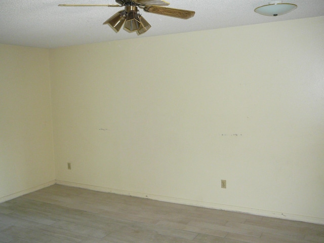 empty room with ceiling fan, a textured ceiling, and light hardwood / wood-style flooring