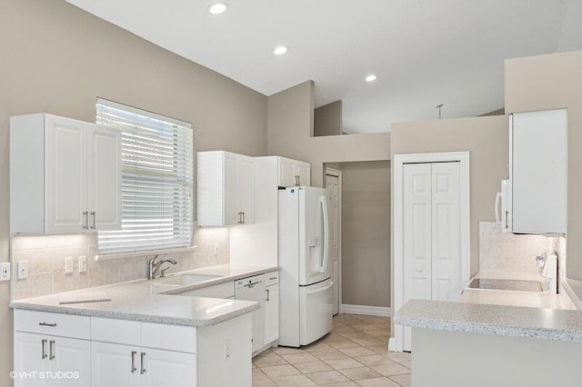 kitchen featuring kitchen peninsula, white appliances, and white cabinetry