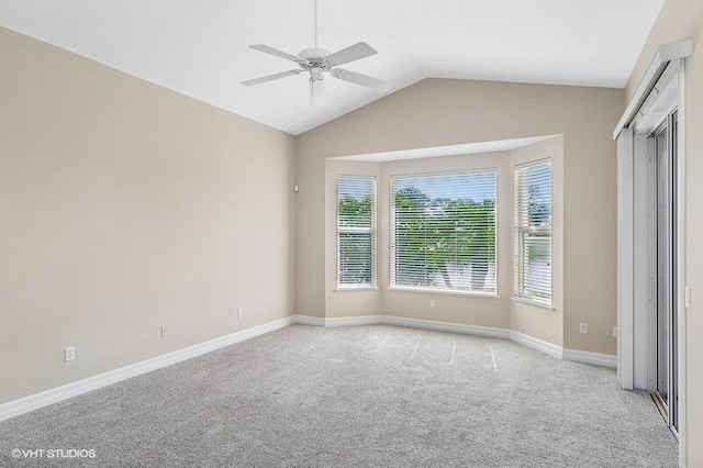 unfurnished bedroom featuring ceiling fan, light colored carpet, and lofted ceiling