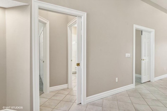 hall featuring light tile patterned floors