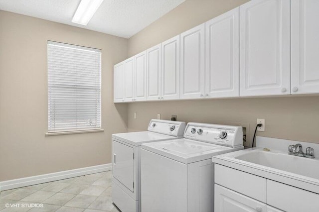 laundry room with cabinets, sink, and washing machine and clothes dryer