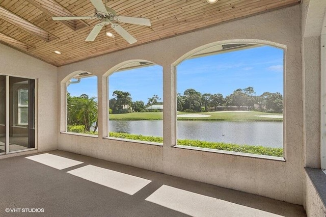 unfurnished sunroom featuring ceiling fan, lofted ceiling, wood ceiling, and a water view