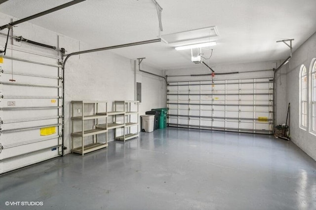 garage with electric panel and a garage door opener