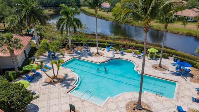 view of pool with a water view and a patio area