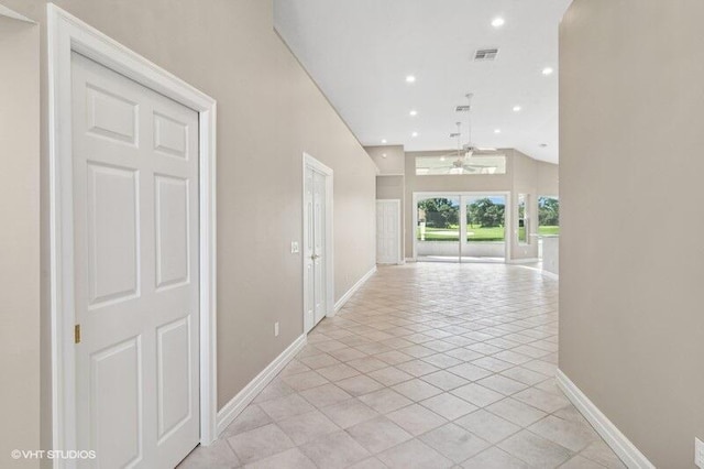 hall featuring light tile patterned floors