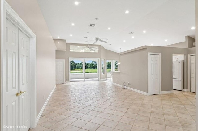 unfurnished living room with light tile patterned floors, lofted ceiling, and ceiling fan