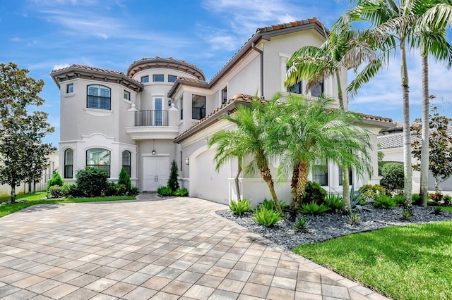 mediterranean / spanish house featuring a balcony and a garage