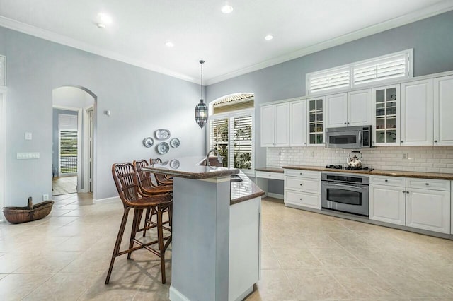 kitchen featuring white cabinets, an island with sink, stainless steel appliances, and sink