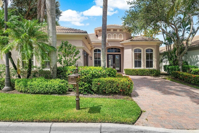 mediterranean / spanish-style home with french doors