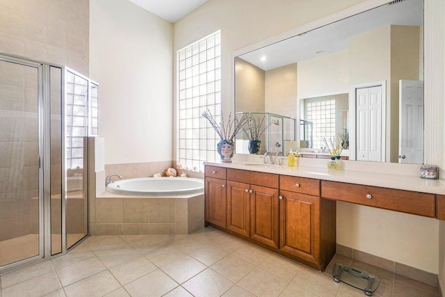 bathroom featuring tile patterned floors, a healthy amount of sunlight, vanity, and shower with separate bathtub