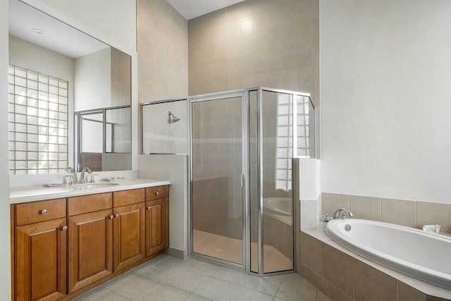 bathroom featuring vanity, tile patterned flooring, and shower with separate bathtub