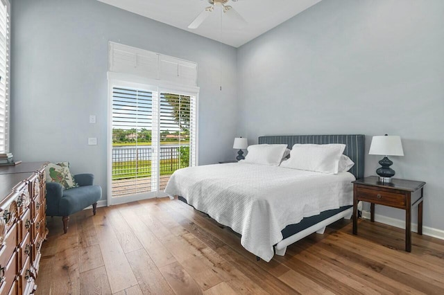 bedroom with light hardwood / wood-style flooring, ceiling fan, and access to outside