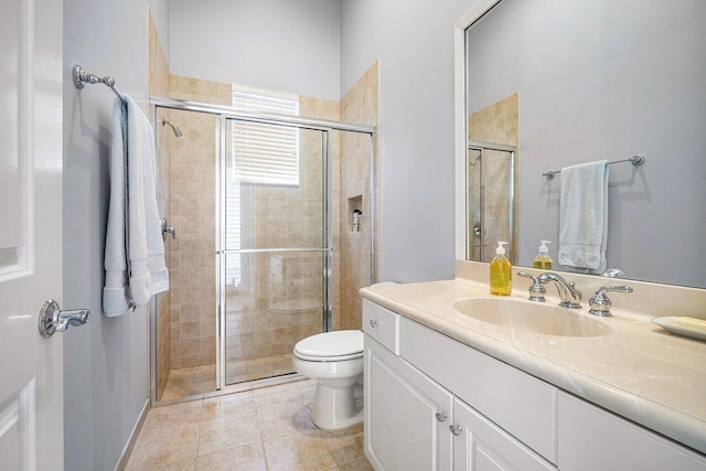 bathroom with vanity, toilet, tile patterned floors, and walk in shower