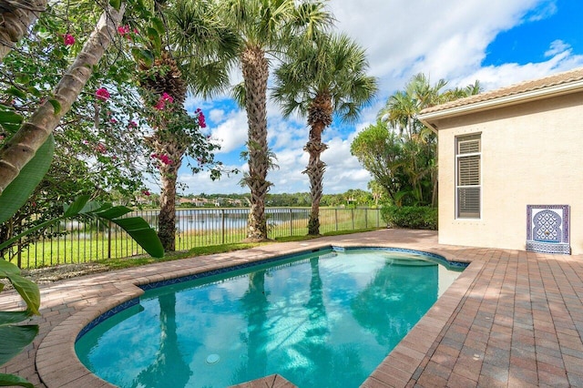 view of swimming pool featuring a water view and a patio