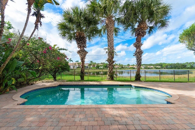 view of swimming pool with a patio and a water view