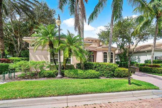 mediterranean / spanish-style house with a front lawn