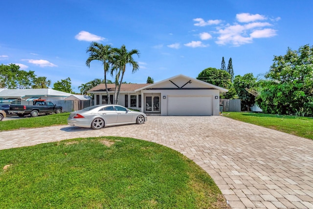 ranch-style home featuring a garage and a front yard