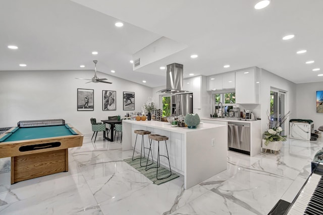 kitchen featuring billiards, a breakfast bar area, white cabinets, a center island, and stainless steel appliances