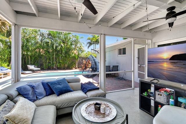 sunroom featuring beam ceiling and ceiling fan