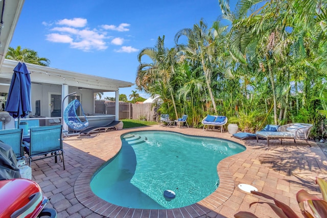 view of swimming pool with a hot tub and a patio