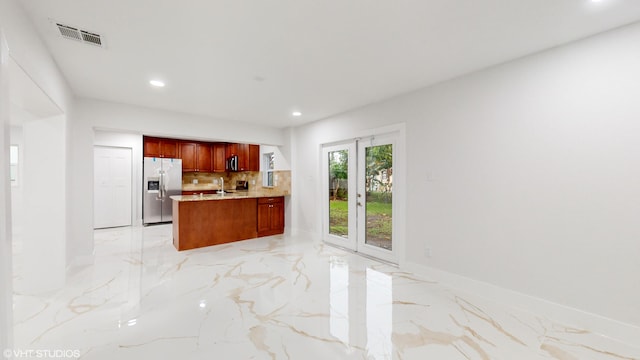 kitchen with backsplash, sink, and stainless steel appliances