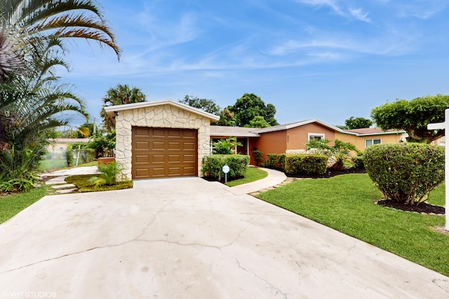 ranch-style house featuring a front yard and a garage