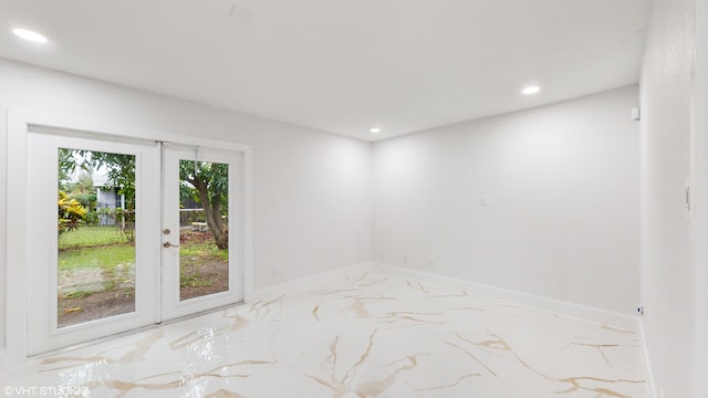 unfurnished room featuring french doors