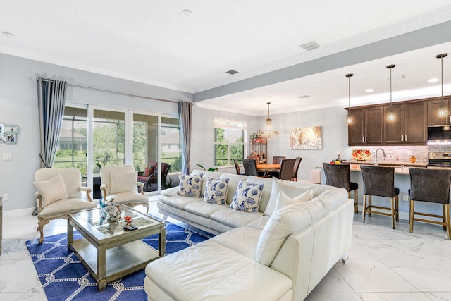 living room with crown molding, french doors, and sink