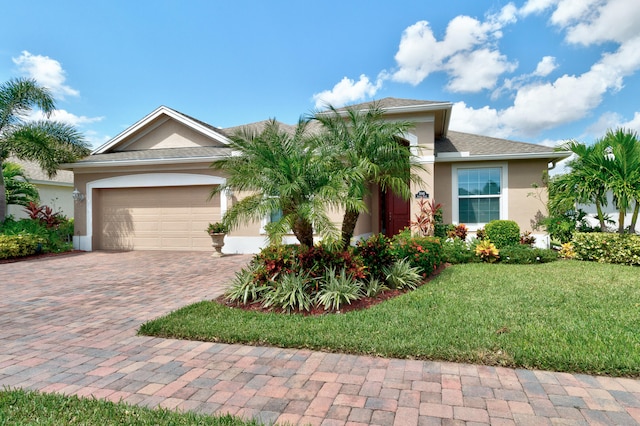 view of front of home featuring a front yard and a garage