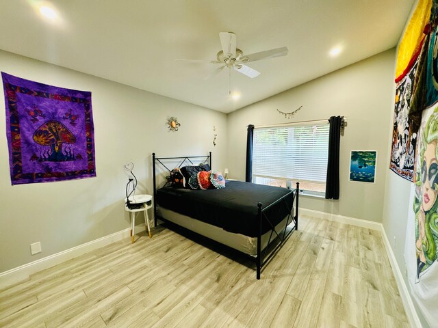 bedroom with light hardwood / wood-style flooring and ceiling fan