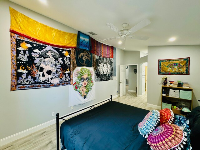 bedroom with ceiling fan, light wood-type flooring, and vaulted ceiling